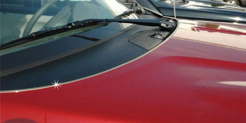Chrome U-channel edge guard trim on red car hood near windshield, front view