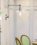 Top Tier Adjustable Swing Arm Wall Sconce With Hand Blown Glass Shade And Hella Bright Up Down Ambient Glow E27 Bulb Suits Bedroom Bedside And Study Reading In Cool Green Bronze mounted next to a dining table.