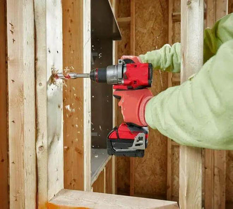 User operating Badass 18V 1/2-Inch Compact Cordless Drill Driver Bit Socket Adapter against wooden wall.