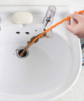 Person using 4 Piece Drain Auger Set For Hair Clog Removal With Bendable Plastic And Stainless Steel Drain Snakes For Kitchen Sink