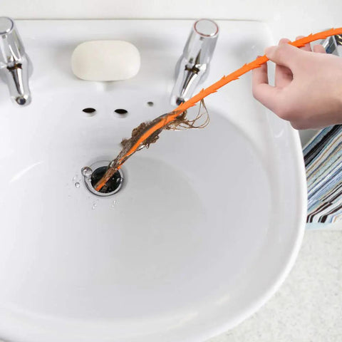 Person using 4 Piece Drain Auger Set For Hair Clog Removal With Bendable Plastic And Stainless Steel Drain Snakes For Kitchen Sink