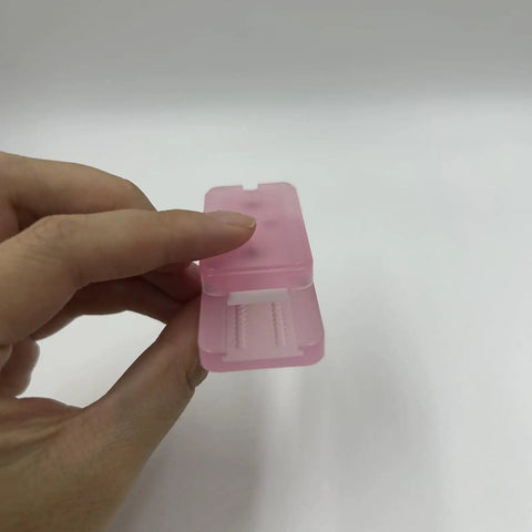 Pink Ding Ding Fidget Slider For Adults Kick Stress To The Curb With This Grab And Go Everyday Carry Gadget Featuring A Sick Clicky Pei Build And Soothing Haptic Feedback Anxiety Relief Pocket Toy held in hand, showing compact PEI design.