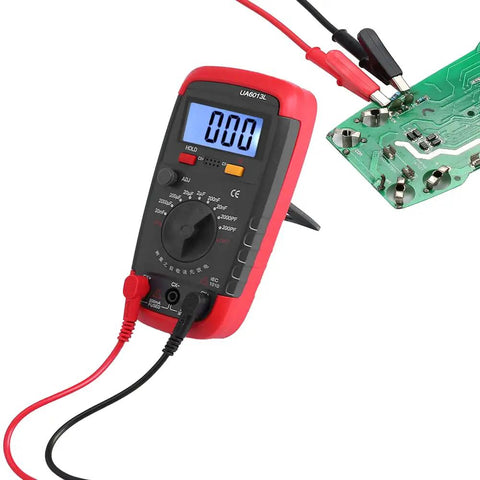 Pro Digital Capacitance Meter And Multimeter Capacitance Tester Handheld 0.1 pF To 20 000 uF connected to circuit board