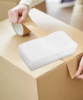 White Epe Foam Wrap Pouches 200 Pack Heavy Duty Cushion Wrap for electronics, resting on a box being taped closed.