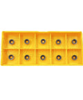 Yellow plastic organizer tray holding ten round carbide inserts.