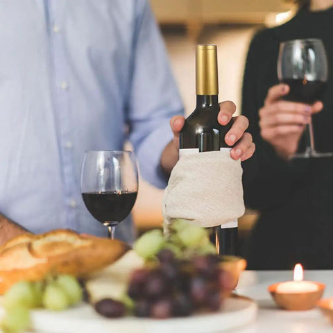Premium Heat Shrink Wine Bottle Caps 100 Pack Flexible PVC Sealing Film on wine bottle with glasses and food.