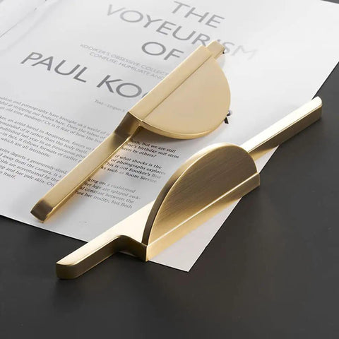 Brushed Gold Half Moon Cabinet Pulls 64mm Center to Center, 7.5 Inch Overall Length, zinc alloy drawer handles displayed on table