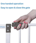 Person operating Walk Through Baby Safety Gate Set With 3.5 Inch Extension For Openings From 29.5 To 36.5 Inches, Pressure Mounted Security Gate White