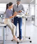 Smooth Roll Mobile Standing Desk With Height Adjustable Pneumatic Lift Sleek Black Aluminum Frame Ergonomic Rolling Workstation in use.