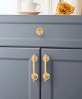 2 Pack 5 Inch Self Stick Cabinet Handles With Adhesive Gold Metal Drawer Pulls for cabinets, installed on gray cabinet