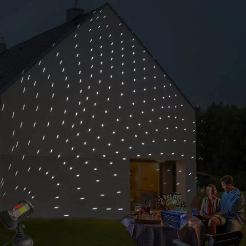 Bluetooth Motion Laser Lights With Dope 7 Color Full Spectrum White Star Effects projecting on house, couple near table