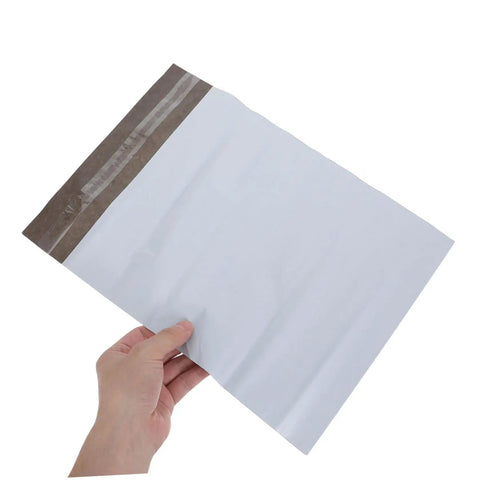 Hand holding Self-Seal White Poly Mailer Bags 100 Pack 10x14 Inches Waterproof And Tear-Resistant Shipping Bags For Clothes.