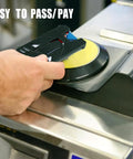 Person using a payment card at a contactless terminal machine with 'TEASY TO PASS/PAY' text visible.