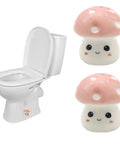 Super Dope Ceramic Toilet Bolt Covers That Straight Up Fix Your Bathroom Vibe With Charming Pink Mushroom Flange Caps next to a toilet.