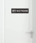 Unisex Restroom Sign 7 Inch By 2 Inch Metal With Self Adhesive Backing For Office Home Bathroom Wall Or Door Decor Easy Mounting UV Protected Black 2 Pack on white door.
