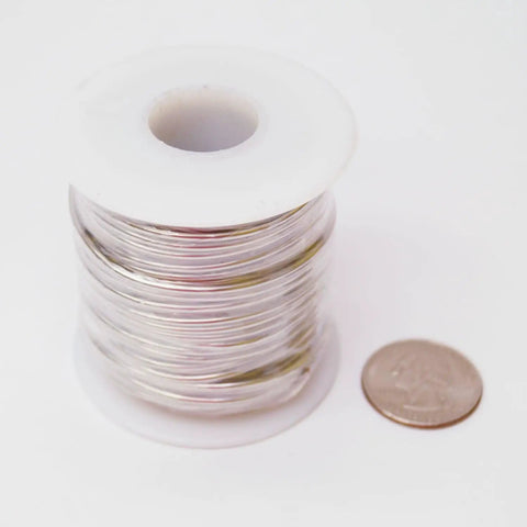 14 Gauge Pre Tinned Copper Wire 1 Pound Spool One Sixteenth Inch Diameter About 350 Feet Long Solder Ready Wire next to a coin