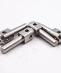 Four stainless steel waterjet poppet pins with square blocks for marble cutting machines.