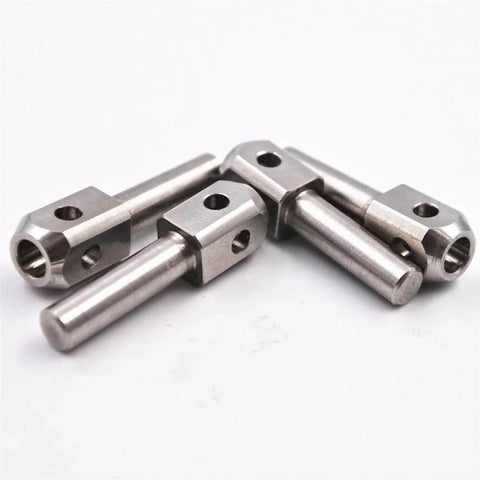 Four stainless steel waterjet poppet pins with square blocks for marble cutting machines.