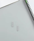 Heavy Duty 40 Pack Stainless Steel Click Pen Springs For Replacement Refills And Repair Kits To Fix Ballpoint Pens Fast With Smooth Compression Action, two springs on notebook