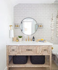 Bathroom with brick wall, round mirror, and Mid Century Modern Gold Crystal Wall Sconce Set Of Two With Glass Rods Brass Finish