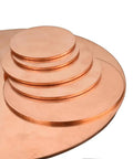 Built Different Heavy Gauge Copper Washers Circular Solid Plates stacked in varying sizes for CNC machining and plumbing projects.
