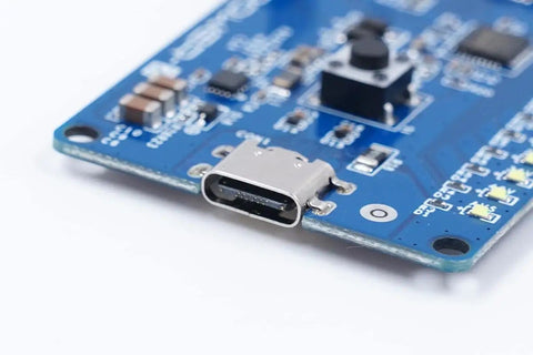 Close-up of Power-Z SINK240 USB PD3.1 Trigger Board showing USB-C port, electronic components on blue circuit board.