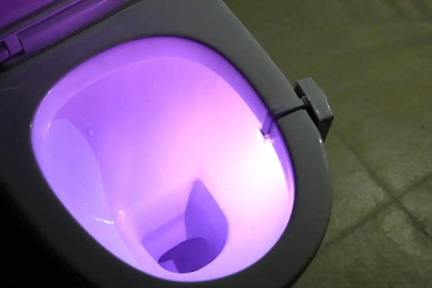 Toilet Night Light Motion Sensor LED Lamp 2 Pack 8 Color Changing Bathroom Nightlight illuminating toilet bowl with purple light.