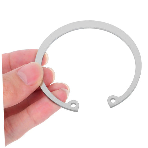 Close-up of a hand holding a piece from the Heavy Duty Stainless Steel C Clip Retaining Rings Kit For Grooved Shafts A Workhorse Snap Ring Set