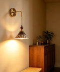 DWEIHDV Ceramic Wall Sconce Vintage Gold Wall Light Fixture with striped ceramic shade and brass body in a cozy corner.
