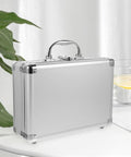 Tough As Nails Aluminum Storage Case With Secure Snap Latch And Plush Foam Padding For Guarding Cameras Cosmetic Kits And Power Tools On Weekend Getaways While Rolling Out, shown from the side on a table.