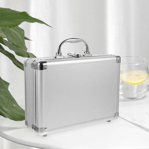 Tough As Nails Aluminum Storage Case With Secure Snap Latch And Plush Foam Padding For Guarding Cameras Cosmetic Kits And Power Tools On Weekend Getaways While Rolling Out, shown from the side on a table.
