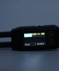 Close-up of Digital SMD Tweezers ESR Meter Handheld Multimeter with illuminated display showing various measurements.