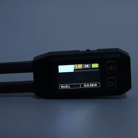 Close-up of Digital SMD Tweezers ESR Meter Handheld Multimeter with illuminated display showing various measurements.