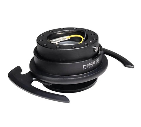 Easy Plug And Play Quick Release Steering Wheel Kit With Gen 4.0 Adapter Black Body And Ring With Handles 6x70mm And 6x74mm Bolt Patterns Horn Wiring Ready Secure Install For Cars And Trucks. Close-up of black adapter with handles and wiring.