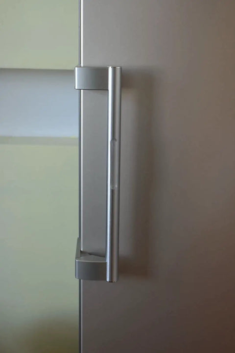 Close-up of refrigerator door handle with Extra Long Silencer Pads 20 Pack For Soft Close And No Slams Ultra Quiet Dampers applied.
