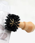 Espresso Portafilter Cleaning Brush with wood handle and stiff nylon bristles scrubbing coffee basket fitting 58mm espresso machines.