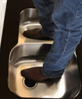 Man standing in double bowl sink showing strength of Undermount Sink Bracket Kit 10 Pack For Solid Surface Countertops No-Fuss Easy-Install