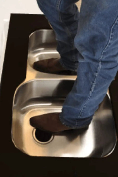 Man standing in double bowl sink showing strength of Undermount Sink Bracket Kit 10 Pack For Solid Surface Countertops No-Fuss Easy-Install