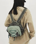 Person wearing a Lightweight Nylon Camping Backpack With Breathable Comfort Large Capacity Grey Build Durable Scratch Resistant Material Smooth Zippers For Easy Access Multi Carry Options From Backpack To Crossbody Go To Outdoor Adventures