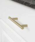 Golden Champagne Euro Bar Cabinet Handle 3/8 Inch Diameter 7-3/8 Inch Length 5 Inch Hole Center mounted on white cabinet