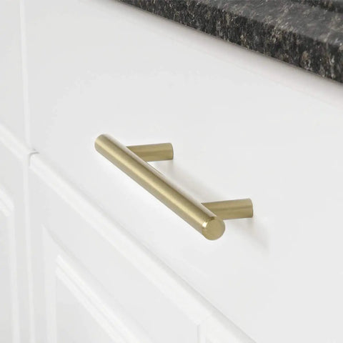Golden Champagne Euro Bar Cabinet Handle 3/8 Inch Diameter 7-3/8 Inch Length 5 Inch Hole Center mounted on white cabinet