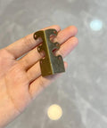 Top Shelf Solid Brass Baseboard Corner Guards For Walls And Skirting Boards, Vintage Bronze Edge Protectors For Furniture And Door Frames, Built Tough Rustproof Wall Bumpers With Screws Included displayed in hand.