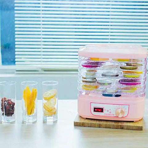 Smooth Operator Electric Food Dehydrator Machine With Five Adjustable Trays And Digital Timer in pink, with dehydrated fruits displayed.
