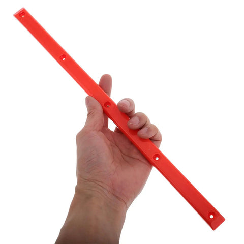 Hand holding orange ABS rail guard for longboards and electric skateboards showcasing easy install and impact resistance.