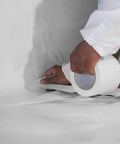 Applying Heavy Duty Vapor Barrier Tape 4 Inch By 180 Feet Polyethylene Seam Tape for moisture barrier sealing, white finish. Hand visible.