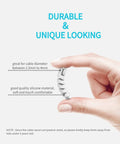 Hand holding a grey silicone cable protector from the Silicone Cable Protectors 12 Pack For Phone Tablet Laptop And Charger Cables Durable Saver End Caps That Prevent Fraying Extend Cable Life Easy Snap On Headphones USB Cables Grey