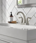 Arvo Centerset 2-Handle Bathroom Faucet in Brushed Nickel, SpotShield Stainless Finish on a white sink with chevron tile background.