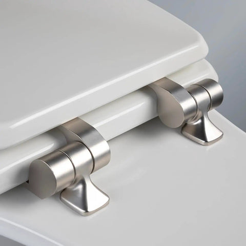 Close-up of brushed nickel hinges on round white toilet seat with slow close wood seat, made in USA, showing secure metal hinges.