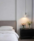 Terrazzo Small Pendant Light, 4.7 Inch Chrome Hanging Fixture above bedside table with flowers and cozy bedding.