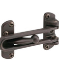 Built Tough Swing Bar Lock For Hinged Doors With Secondary Security And Child Safe Ventilation Three And Seven Eighths Inch Bar Diecast Zinc Construction Classic Bronze Finish Easy Install Prime-Line U 10309 in classic bronze with installation screws visible